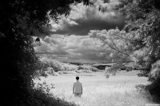 Surreal landscape with man waiting for storm clouds
